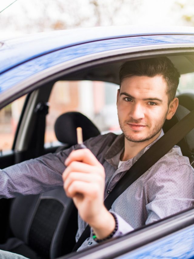 young-handsome-man-driving-his-new-car-holding-out-keys
