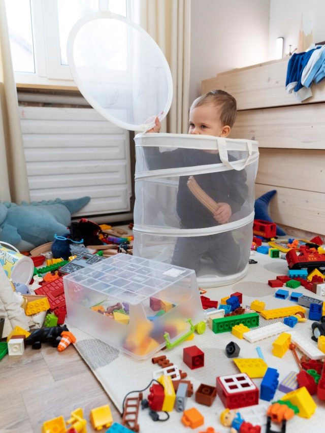 garoto-bonito-de-tiro-completo-brincando-na-sala-de-estar_23-2149311333