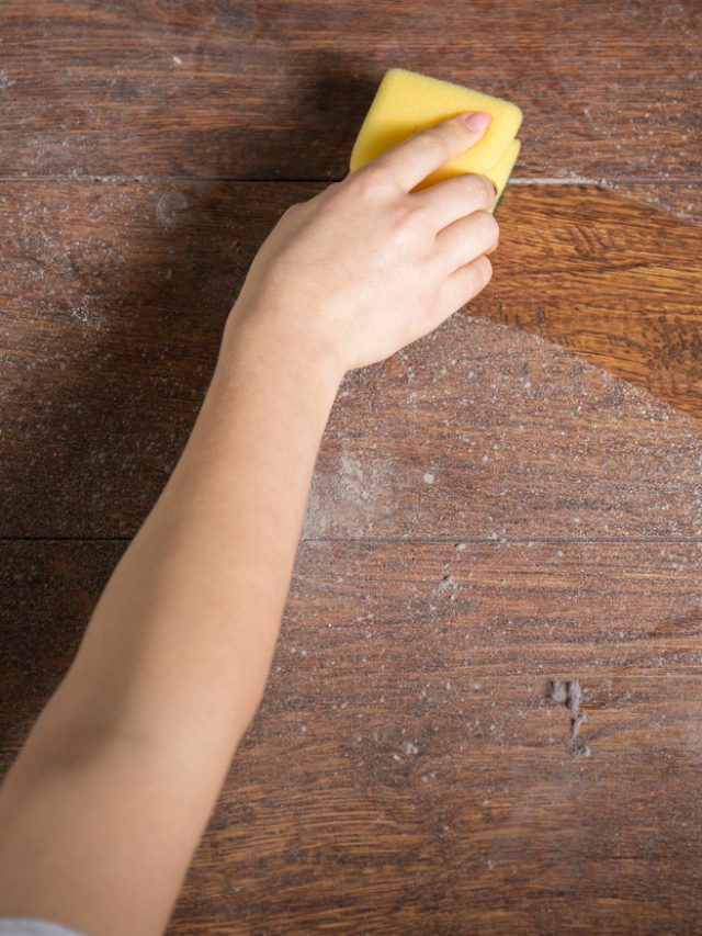 Using sponge for cleaning dusty wood
