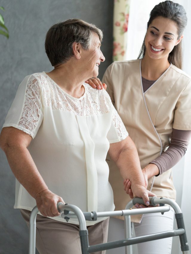 Nurse helping senior to walk